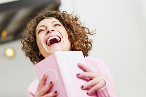 woman_laughing_with_a_book_in_hand